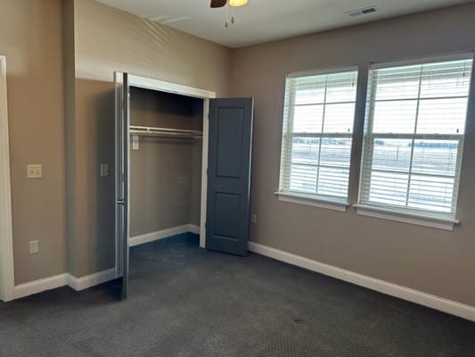 A cozy, well-lit private room with closet space