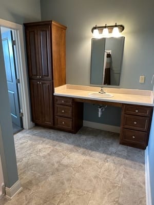 A well-lit interior bathroom with wooden cabinetry