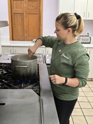 Staff member preparing food in a kitchen