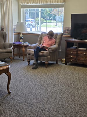 A resident reading in a comfortable common area