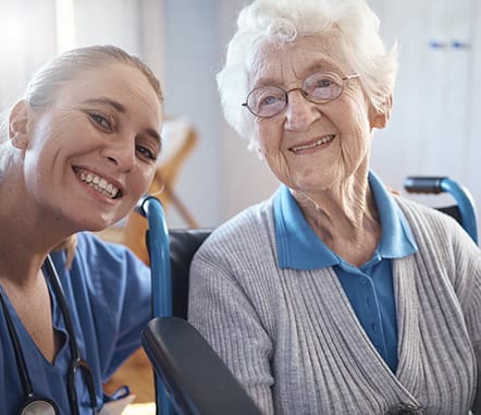 A staff member and a resident smiling together