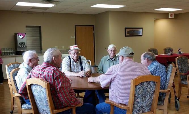 Residents engaged in conversation around a table