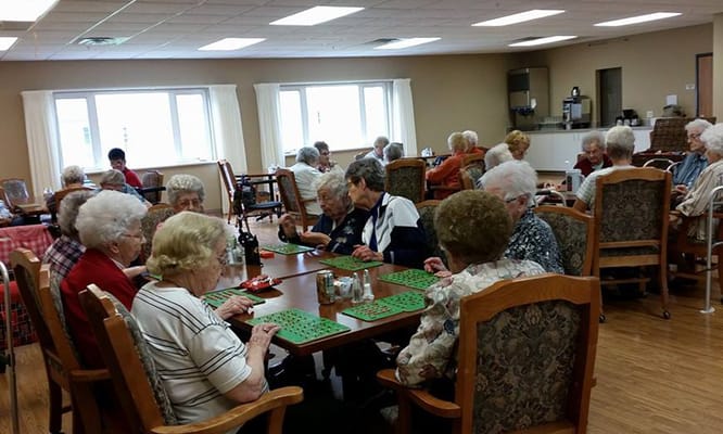 Residents enjoying a bingo game in a common area