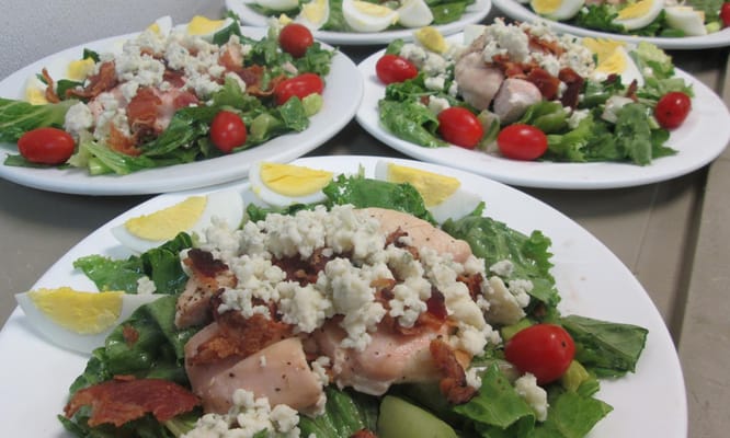 Plates of freshly prepared salads with ingredients