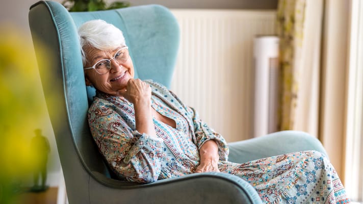 Senior woman relaxing in a cozy chair