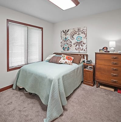 Cozy private resident room with a bed and decor