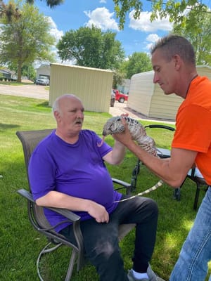 A resident interacting with a staff member outdoors