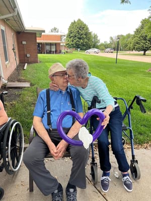 Residents enjoying time outdoors with a balloon heart