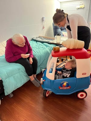 Resident interacting with a child in an activity room