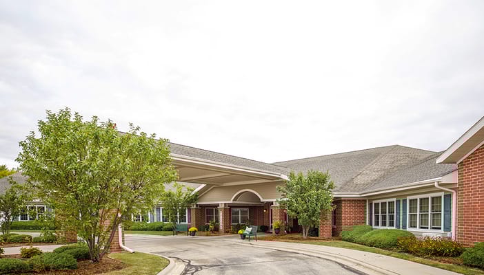 Entrance view of Parkside Manor with landscaped exterior