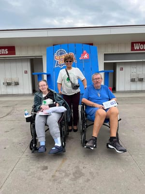 Residents in wheelchairs enjoying an outdoor space