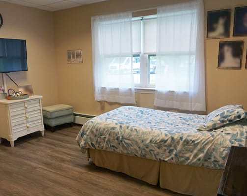 Private resident room with a bed and TV
