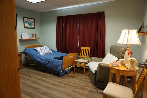 Cozy resident room with bed and chair