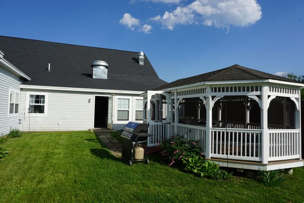 Outdoor seating area with gazebo and grill