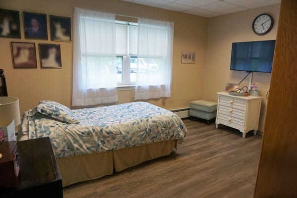 Private resident room with bed and television