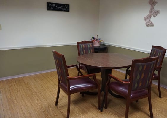 A common area with a round table and chairs