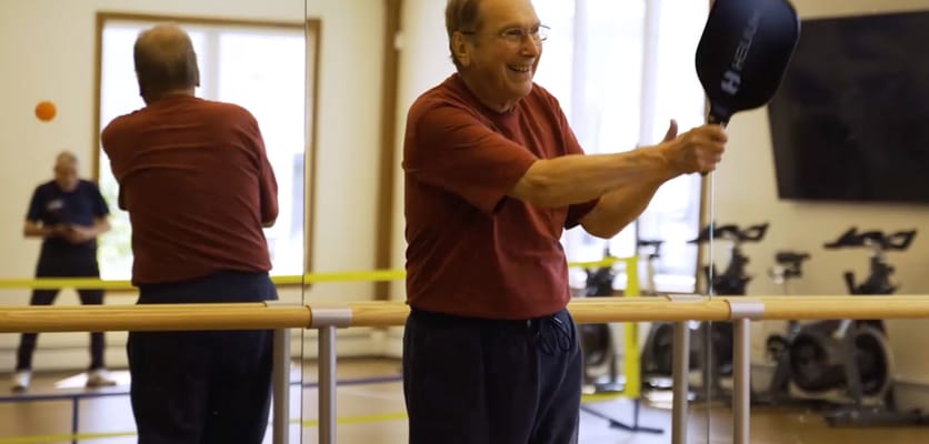 Senior resident enjoying a game with paddle in an activity room