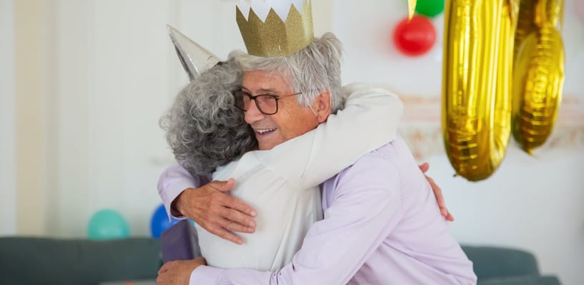 Residents celebrating with joyful hugs at a party