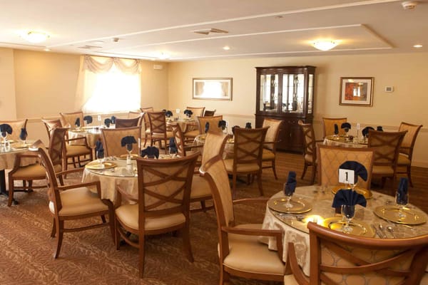 Dining room with elegantly set tables and seating