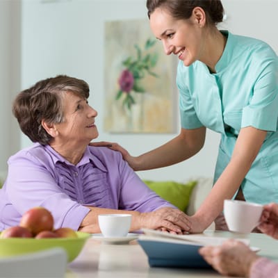 A caregiver interacting with a resident in a common area