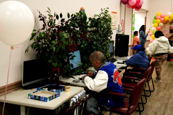 Residents using computers in a common area