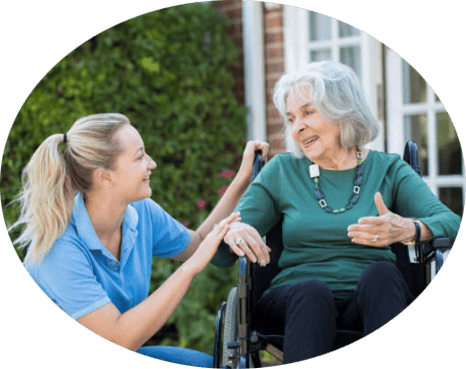Caregiver interacting with an elderly resident outdoors