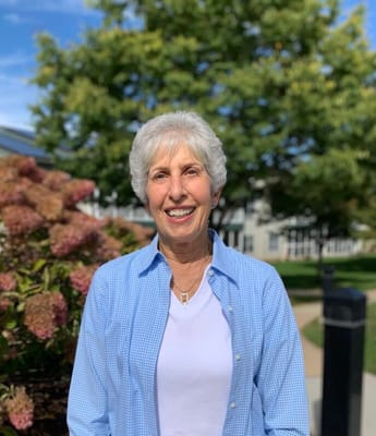 Smiling resident in a garden area