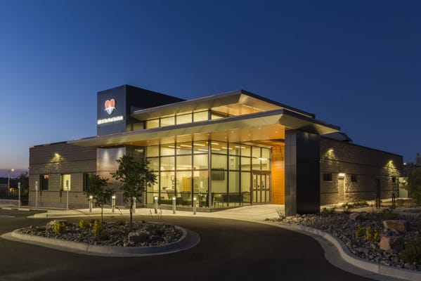 Exterior view of a modern assisted living facility at night