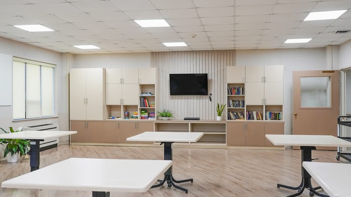 Bright activity room with seating and shelves