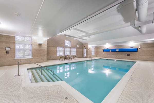 Indoor swimming pool area with seating