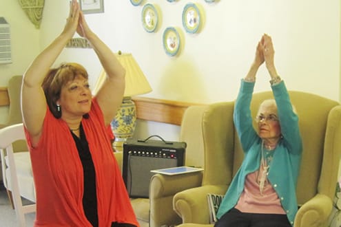 Residents participating in a seated exercise activity
