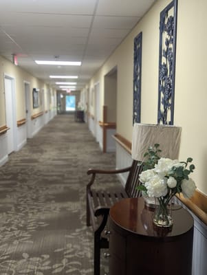Bright hallway with floral decor and seating area