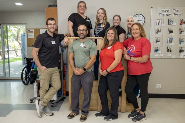 Staff members posing for a photo in the lobby area