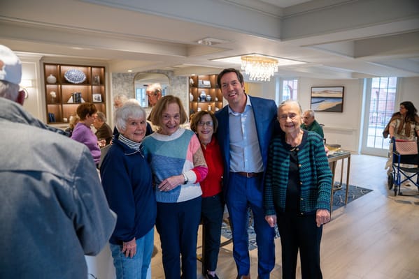 Residents and staff posing together in a common area