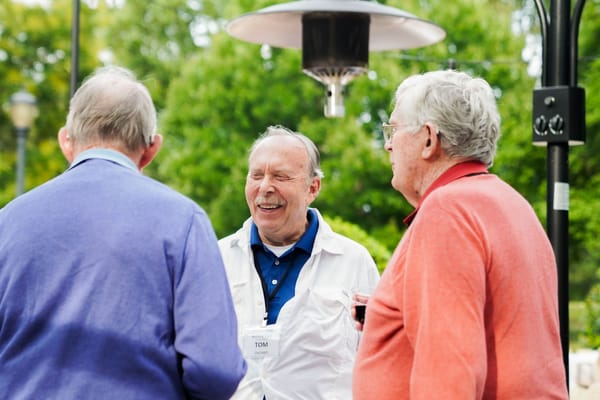 Residents chatting outdoors in a relaxed setting