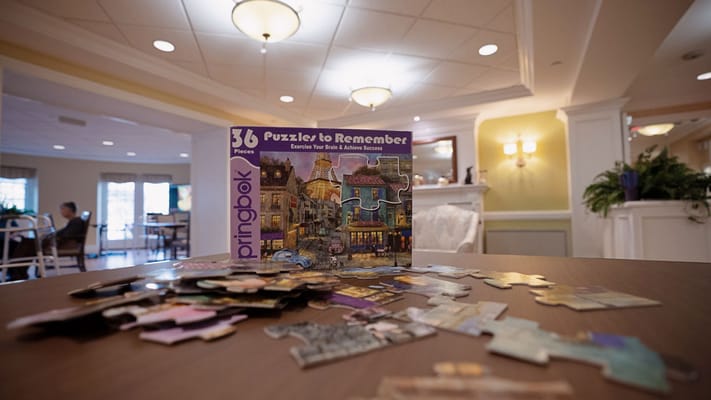 Residents enjoying a puzzle activity in a common area.