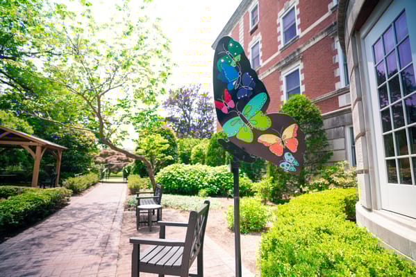 Colorful butterfly sculpture in a garden area