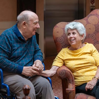 Two residents chatting in a common area