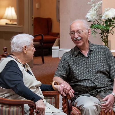 Two residents enjoying a conversation in the common area