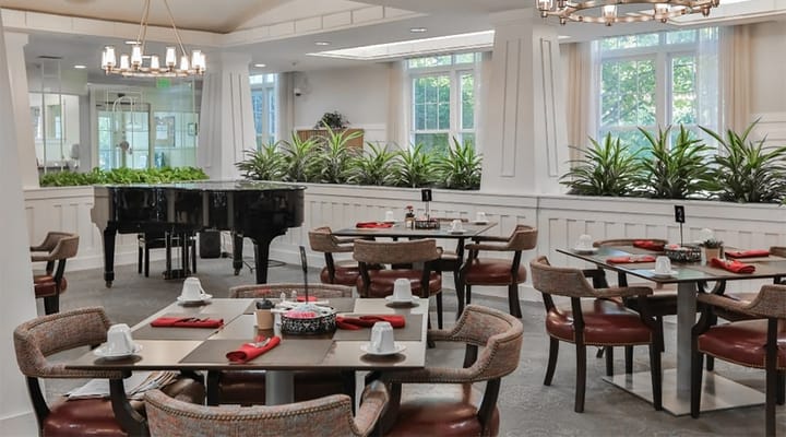 Bright dining room with tables and piano