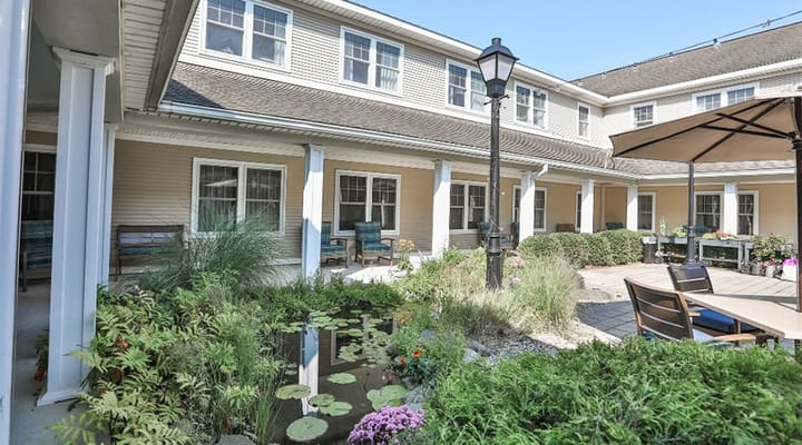 Courtyard with seating and gardens in a senior living facility