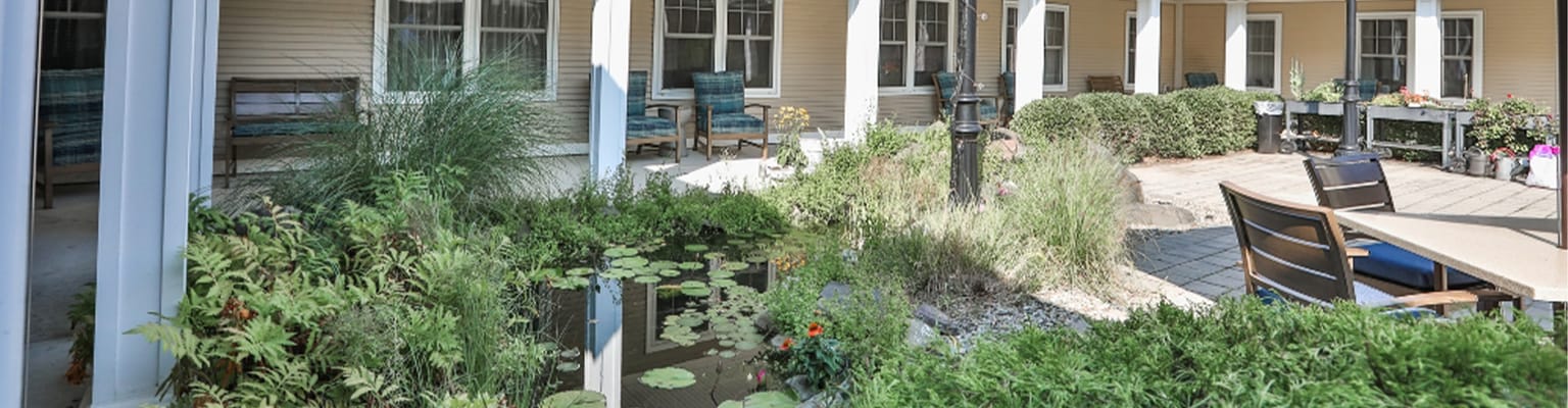 Serene outdoor garden area with seating and water feature