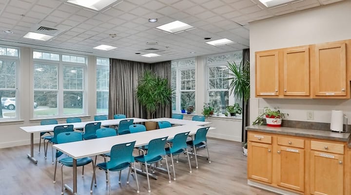 Bright activity room with tables and chairs