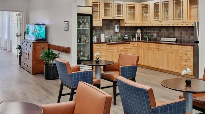 Common area with seating and kitchen area visible