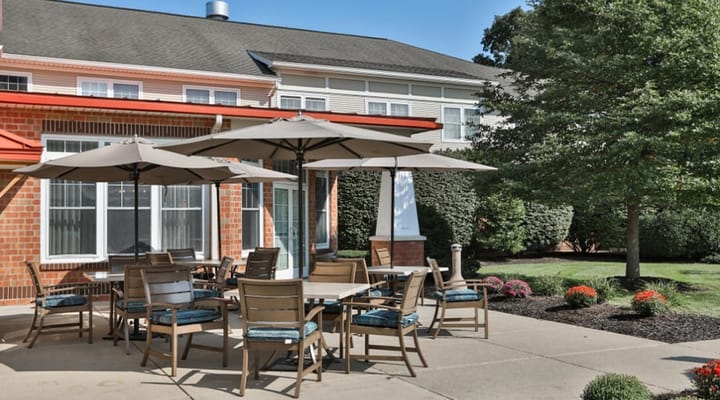 Outdoor seating area with tables and umbrellas