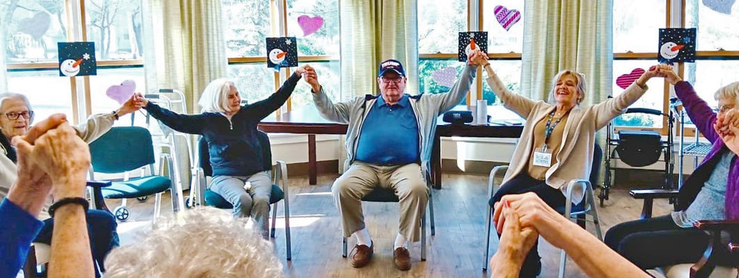 Residents participating in a group activity, holding hands