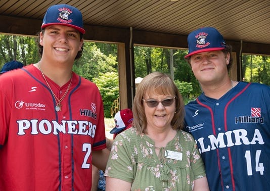 Residents and staff posing for a photo at an outdoor event.