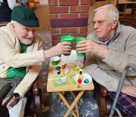 Residents sharing drinks and snacks in a common area