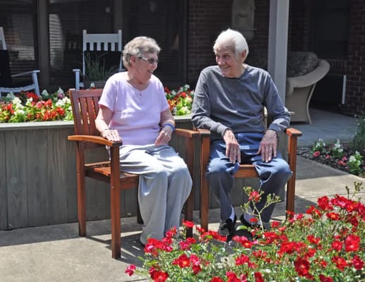 Two residents enjoying time together in the garden
