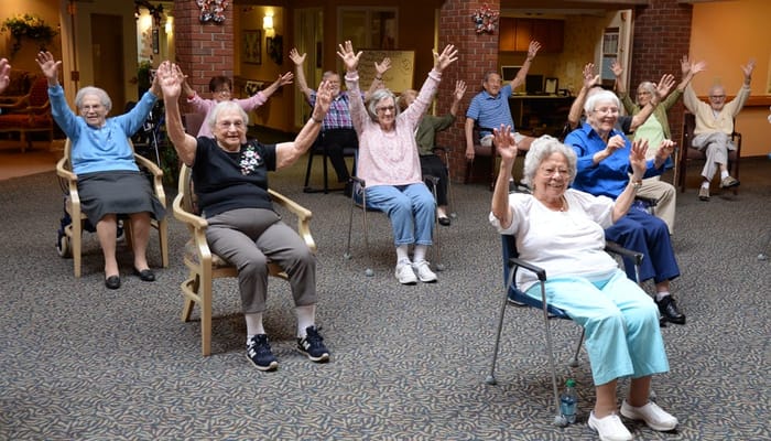 Residents participating in a group activity with raised hands